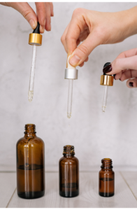 three hands holding microdosing pods